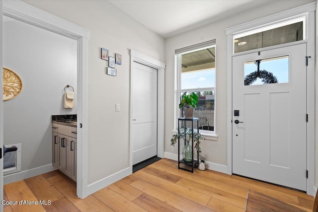 foyer entrance with light wood-type flooring