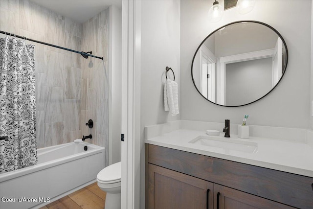 full bathroom featuring toilet, wood-type flooring, shower / tub combo with curtain, and vanity