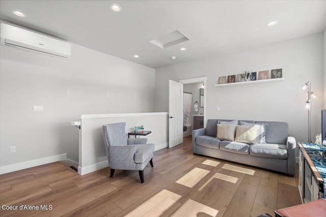 living room featuring light hardwood / wood-style flooring and a wall mounted air conditioner