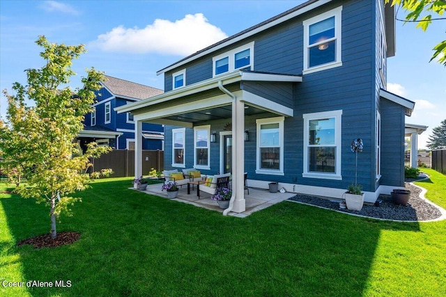 back of house featuring a patio and a lawn