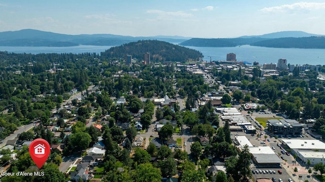 drone / aerial view featuring a water and mountain view