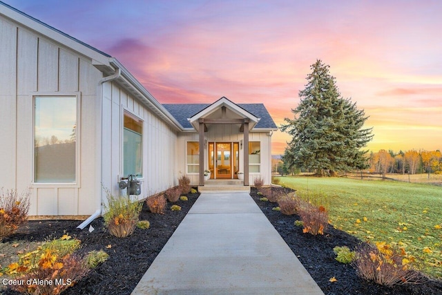 exterior entry at dusk with a lawn