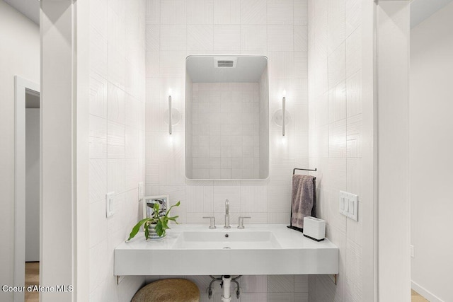 bathroom with tile walls