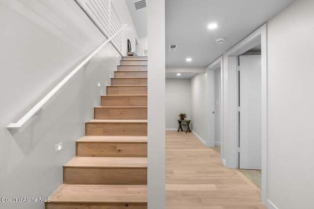 stairway featuring wood-type flooring