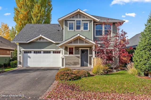 view of front of property with a front yard and a garage