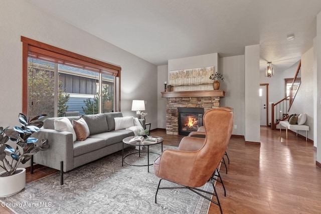 living room featuring wood-type flooring and a fireplace