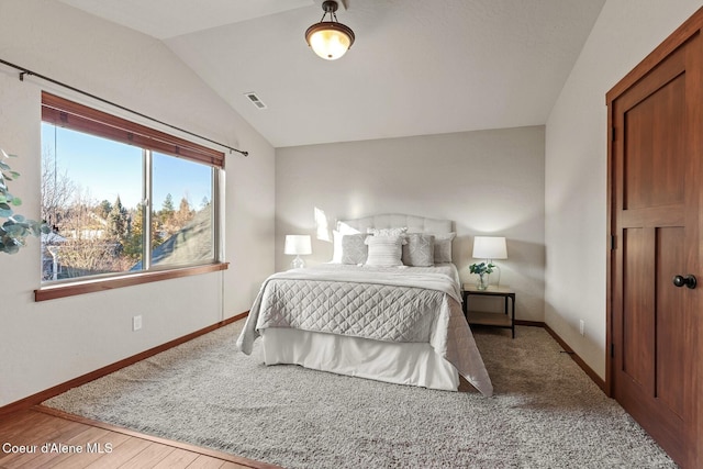 bedroom featuring wood-type flooring and lofted ceiling