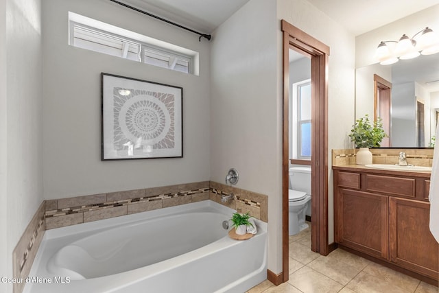 bathroom with toilet, tile patterned floors, a wealth of natural light, and a washtub