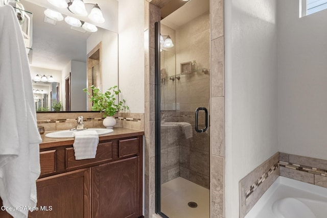 bathroom with shower with separate bathtub and vanity