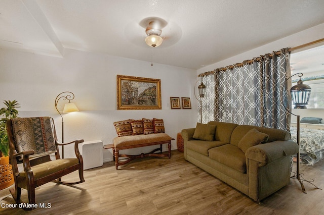 living room with light hardwood / wood-style floors and ceiling fan