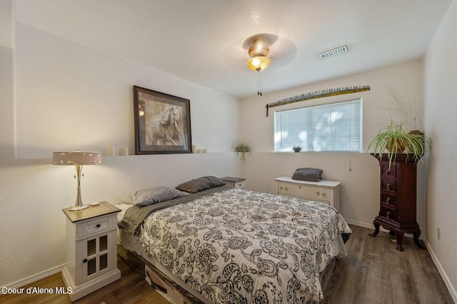 bedroom featuring ceiling fan and dark wood-type flooring