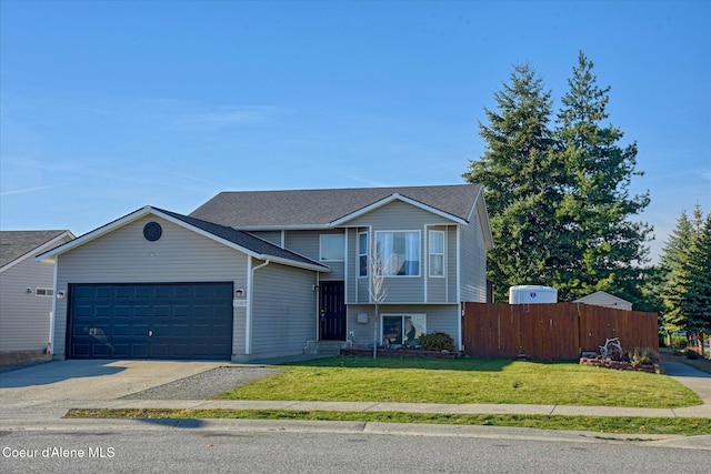 view of front of property featuring a garage and a front lawn