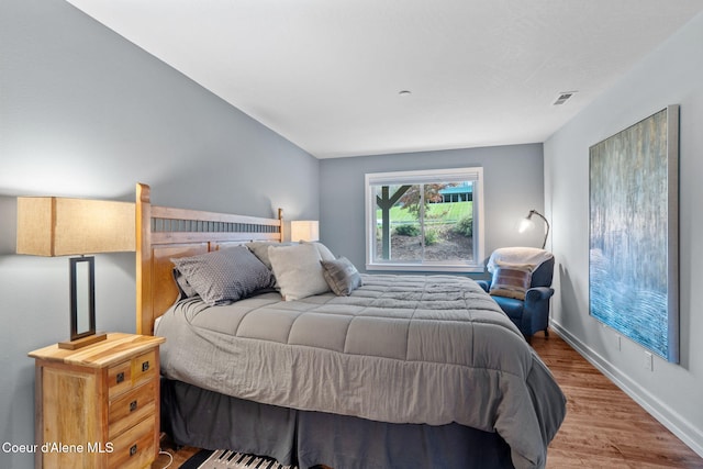 bedroom with hardwood / wood-style flooring