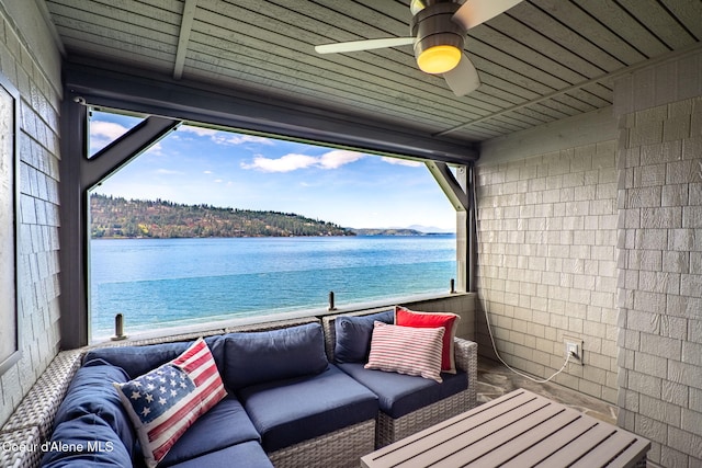 balcony featuring ceiling fan, a water view, and outdoor lounge area