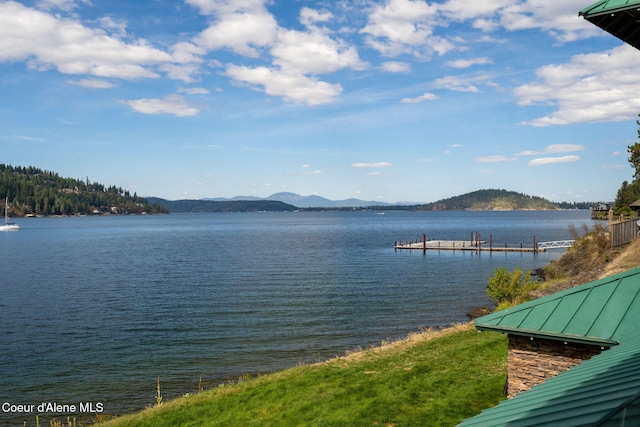 view of water feature with a dock and a mountain view