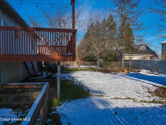 yard covered in snow featuring a wooden deck