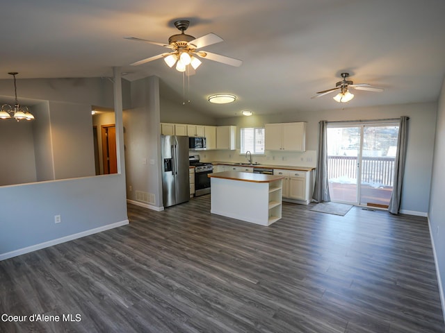 kitchen with ceiling fan with notable chandelier, pendant lighting, white cabinets, a center island, and stainless steel appliances