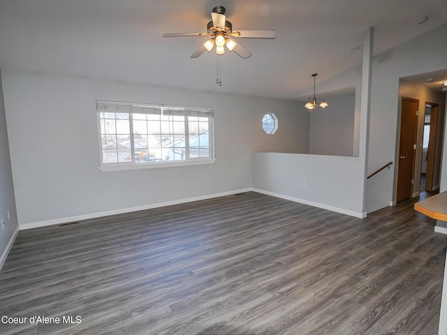 unfurnished room with ceiling fan with notable chandelier, dark hardwood / wood-style floors, and lofted ceiling