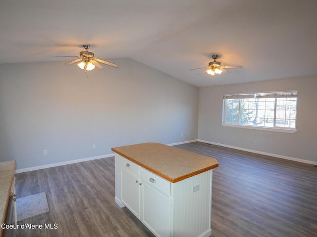 interior space with ceiling fan, dark wood-type flooring, and lofted ceiling