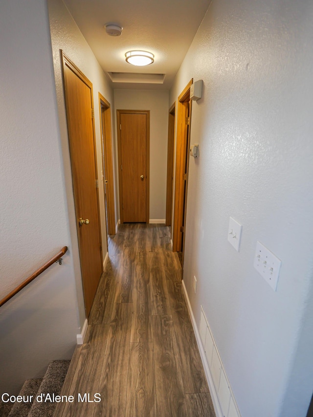 hallway with dark hardwood / wood-style floors