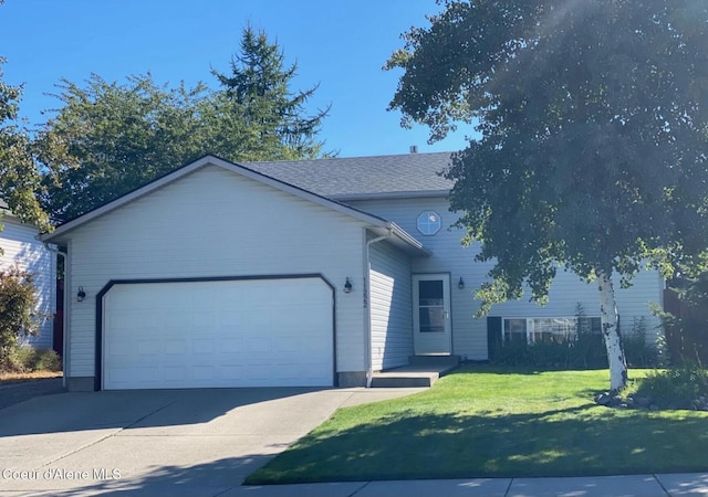 view of front of home featuring a garage and a front yard