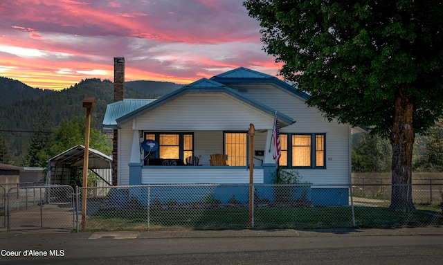 view of front of home featuring a mountain view, covered porch, and a carport