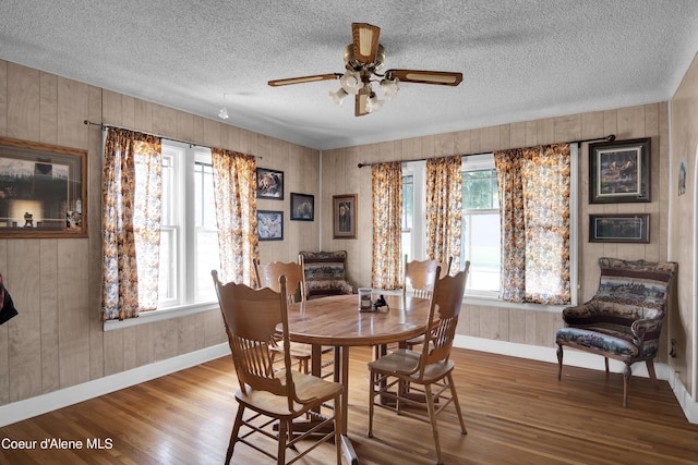 dining area featuring ceiling fan and wood-type flooring