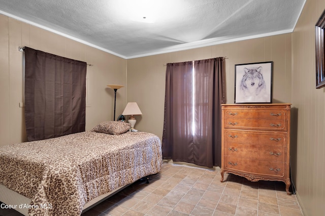 bedroom featuring crown molding and wood walls