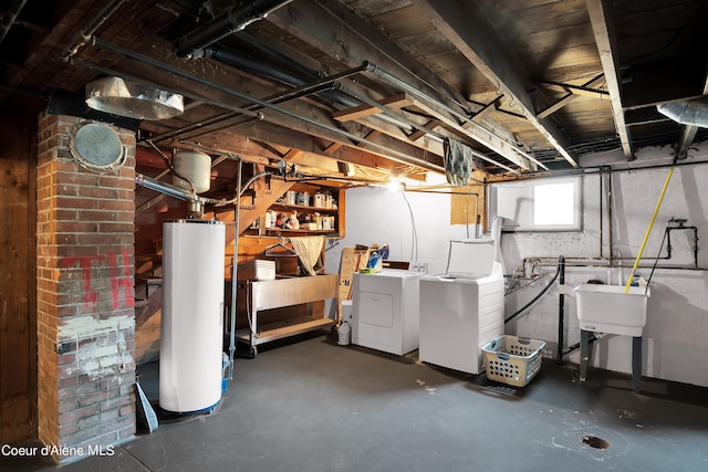 basement featuring separate washer and dryer, sink, and gas water heater