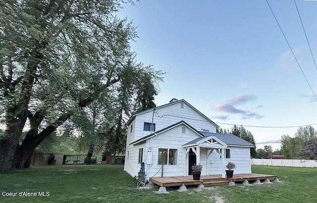 view of front of property with a front lawn and a wooden deck