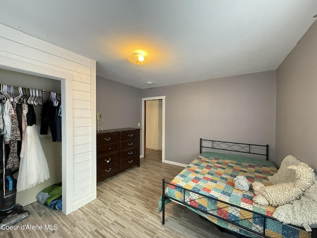 bedroom featuring light wood-type flooring and a closet