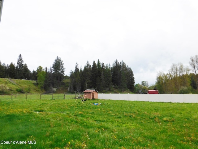 99 Brown Creek Rd, Naples, ID 83847 - view of yard with a storage unit, a rural view, fence, and an outdoor structure