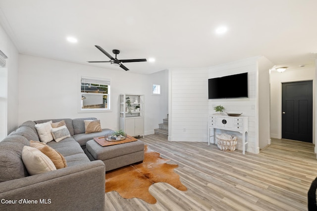 living room featuring ceiling fan and light hardwood / wood-style flooring