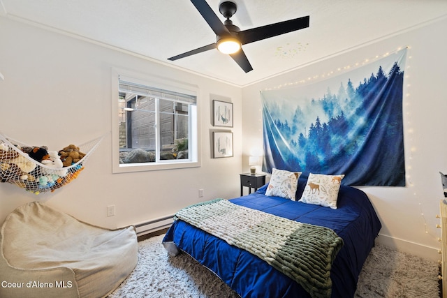 bedroom featuring a baseboard heating unit, ceiling fan, and crown molding