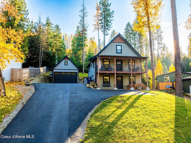 view of front of property featuring a front lawn, a garage, and an outdoor structure