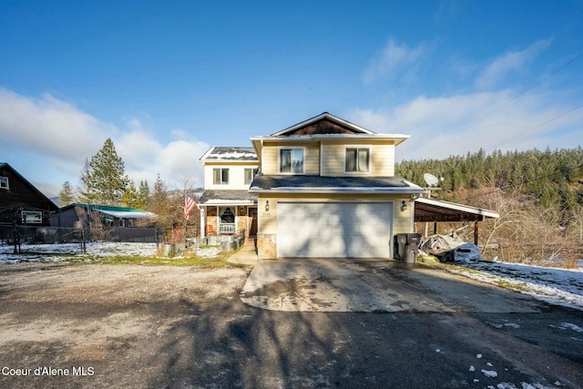 front facade featuring a garage and a carport