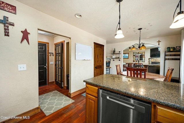 kitchen with dishwasher, dark stone countertops, hanging light fixtures, dark hardwood / wood-style floors, and a notable chandelier