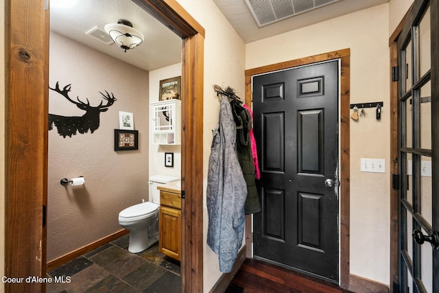 bathroom featuring toilet and vanity