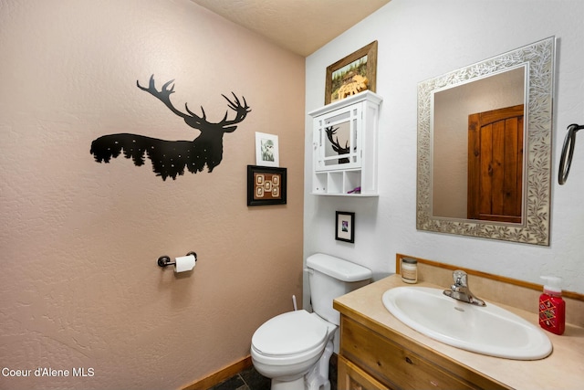 bathroom with toilet and vanity