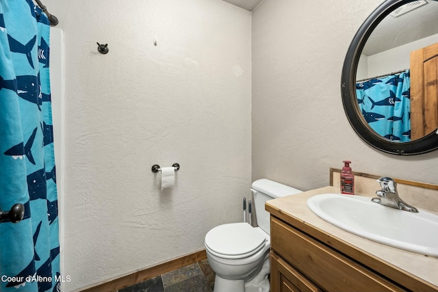 bathroom with toilet and vanity