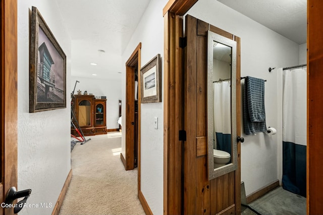 corridor with light colored carpet