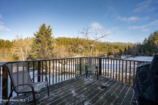 deck with a water view and a grill