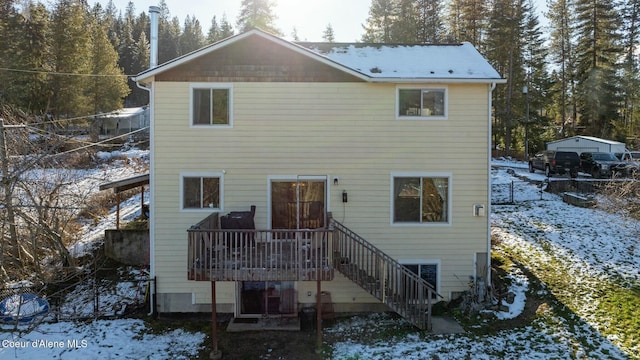 view of snow covered back of property