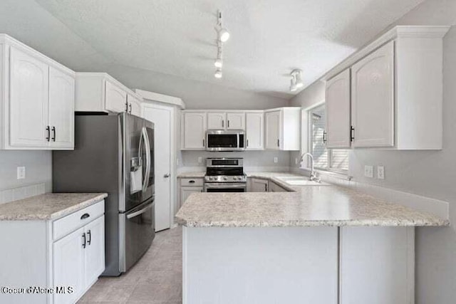 kitchen featuring kitchen peninsula, stainless steel appliances, white cabinets, and sink