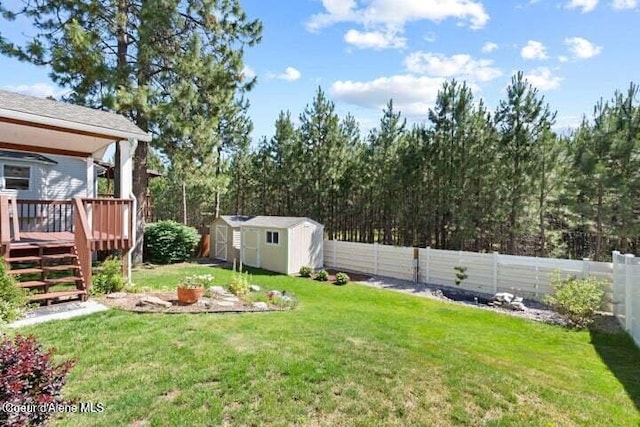 view of yard with a deck and a storage shed