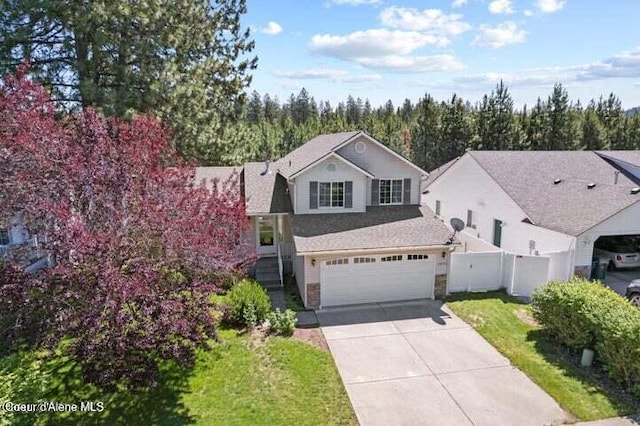 front of property with a garage and a front lawn