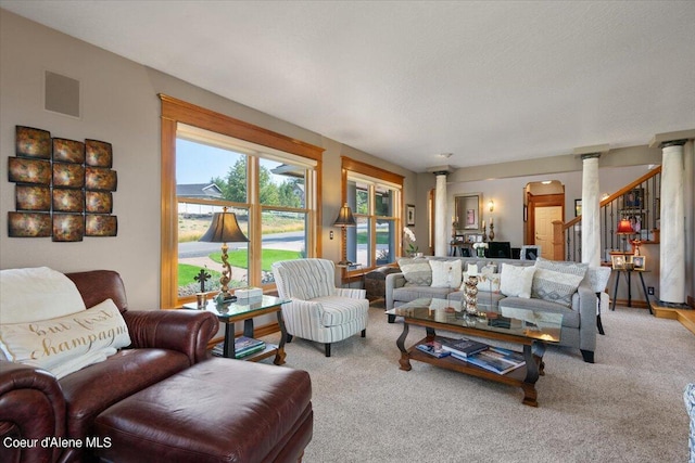 carpeted living room featuring ornate columns