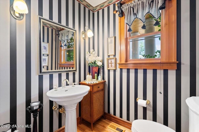 bathroom featuring toilet and hardwood / wood-style floors