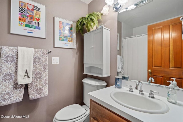 bathroom featuring toilet and vanity