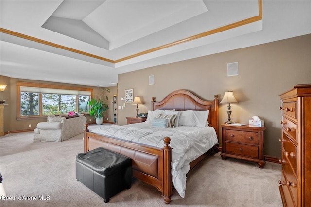 bedroom featuring light colored carpet and a tray ceiling